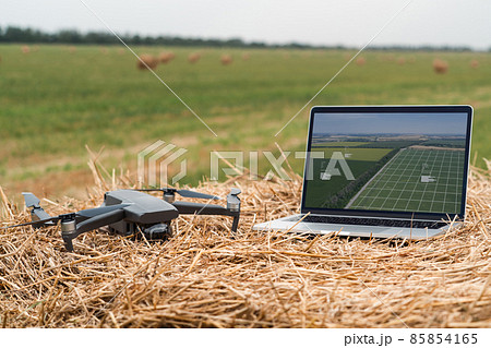 Laptop and drone on the field 85854165
