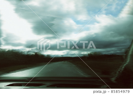 Blurred unfocused view through the moving car windscreen. Glitch retro effect. Blurred unfocused view through the moving car windscreen. Glitch retro effect. 85854979