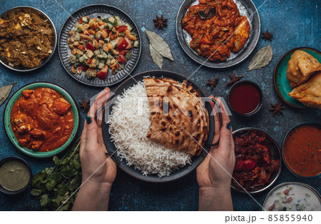 Assorted Indian ethnic food buffet on rustic concrete table from above 85855940