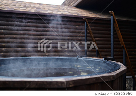Wooden bathtub with stove on outside terrace 85855966