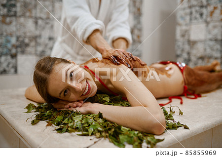 Young woman getting honey massage in sauna 85855969