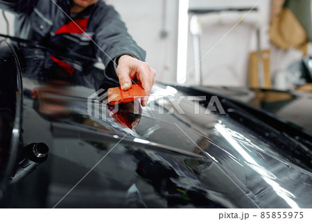 Auto service worker coating luxury black car 85855975