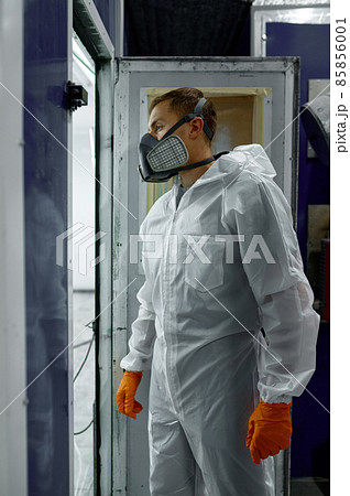 Car painter in protective clothes entering booth Car painter in protective clothes entering booth 85856001