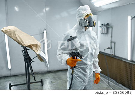 Car mechanic leaving painting chamber after work Car mechanic leaving painting chamber after work 85856095