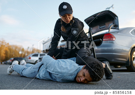 Police officer arresting suspicious young car driver 85856158