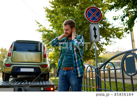 Sad man and evacuation wrong parked car 85856164