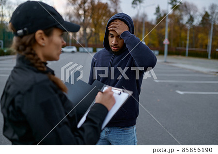 Upset man and police woman issuing fine Upset man and police woman issuing fine 85856190