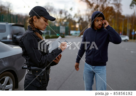 Upset man and police woman issuing fine 85856192