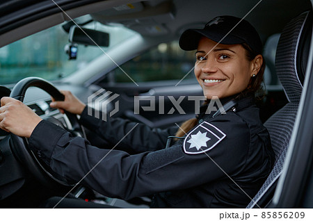 Side view portrait police woman driving car 85856209