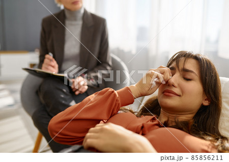 Closeup of young woman with problems crying 85856211