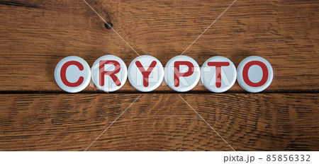 White small circles with letters crypto on wood background. Concept image. White small circles with letters crypto on wood background. Concept image. 85856332