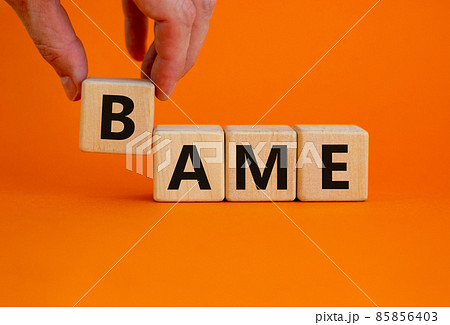 BAME symbol. Abbreviation BAME, black, asian and minority ethnic on wooden cubes. Beautiful orange background. Copy space. Business and BAME, black, asian and minority ethnic concept. 85856403