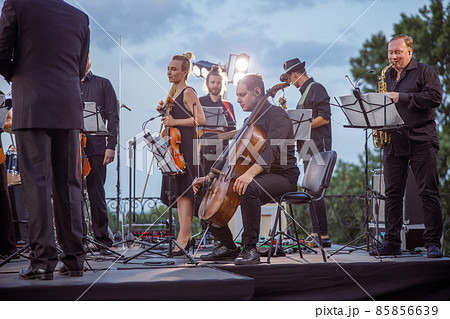 Musical ensemble having concert rehearsal on the street 85856639