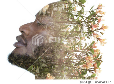 A portrait of a man dissolving into flowers in a double exposure technique. 85858417
