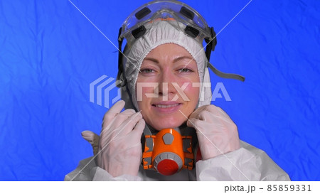 Scientist virologist in respirator. Woman close up look, wearing protective medical mask. Concept health safety N1H1 coronavirus epidemic 2019 nCoV. Scientist virologist in respirator. Woman close up look, wearing protective medical mask. Concept health safety N1H1 coronavirus epidemic 2019 nCoV. 85859331