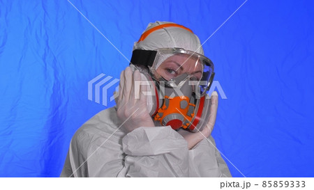 Scientist virologist in respirator. Woman close up look, wearing protective medical mask. Concept health safety N1H1 coronavirus epidemic 2019 nCoV. 85859333