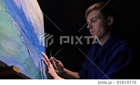 Artist copyist paint seascape with ship in ocean. Craftsman decorator draw as boat sail on blue sea with acrylic oil color. Draw brush, knife palette. 85859776