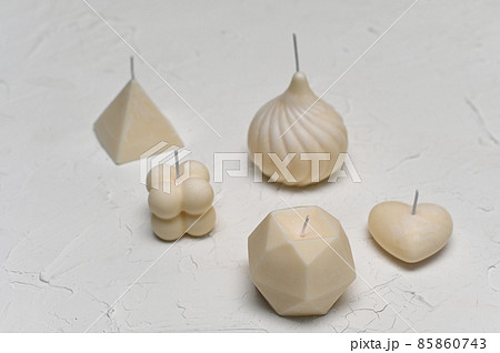 handmade candles. beautiful scented candles on a white plastered background. 85860743