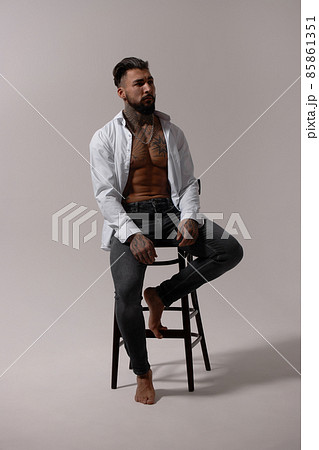 Muscular shirtless tattooed guy in studio Muscular shirtless tattooed guy in studio 85861351