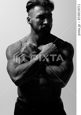 Muscular shirtless tattooed guy in studio Muscular shirtless tattooed guy in studio 85863651