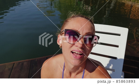 Woman shooting self portrait. Take photo and video on smartphone. Girl rest, relax, walk in sunglasses, make selfie. Blogger broadcast video vlogging. Woman shooting self portrait. Take photo and video on smartphone. Girl rest, relax, walk in sunglasses, make selfie. Blogger broadcast video vlogging. 85863893