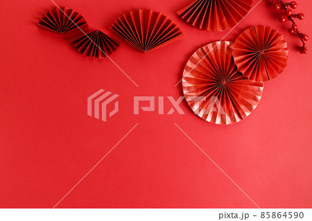 Chinese new year festival decoration with red envelopes and red Chinese folded fans on red background. 85864590