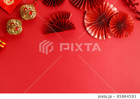 Chinese new year festival decoration with red envelopes and red Chinese folded fans on red background. 85864591