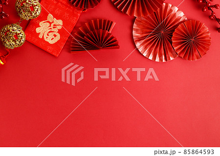 Chinese new year festival decoration with red envelopes and red Chinese folded fans on red background. 85864593