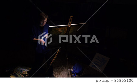 Artist copyist paint seascape with ship in ocean. Craftsman decorator draw as boat sail on blue sea. Black background. Wide angle shot. 85865100