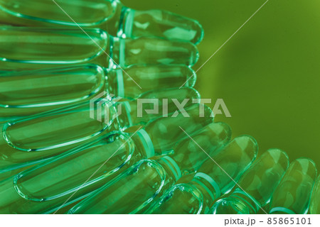Glass medical ampoule vial for injection. Medicine is liquid sodium chloride with of aqueous solution in ampulla. Close up. Bottles ampule multicolor. 85865101