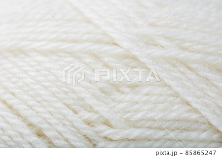 White wool yarn close-up in full screen 85865247