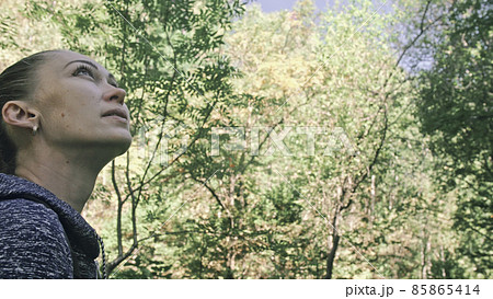 Traveler photographing scenic view in forest. One caucasian woman shooting nice magic look. Girl take photo video on dslr mirrorless camera. 85865414