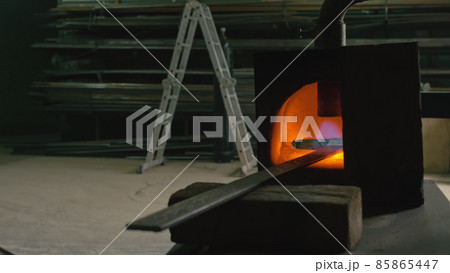 Forge workshop. Smithy manual production. Gas furnace for heating metal. Modern melting stove for iron steel. Blacksmith makes iron products. 85865447