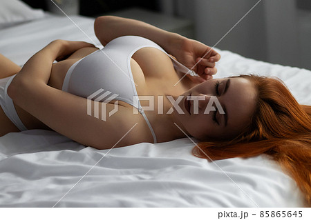 Sensual ginger woman in underwear on bed Sensual ginger woman in underwear on bed 85865645