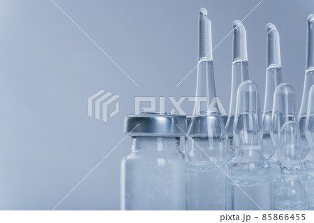 Glass medical ampoule vial for injection. Medicine is dry white drug penicillin powder or liquid with of aqueous solution in ampulla. Close up. Glass medical ampoule vial for injection. Medicine is dry white drug penicillin powder or liquid with of aqueous solution in ampulla. Close up. 85866455
