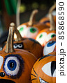 Frightened painted pumkins for halloween on a market vertical 85868590