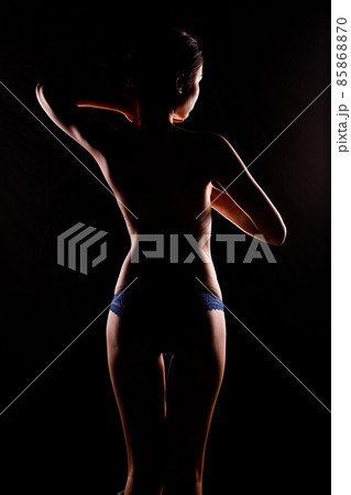 Portrait Swim wear of 20s Asian Woman in shadow low light key with back backlit, side rear view Portrait Swim wear of 20s Asian Woman in shadow low light key with back backlit, side rear view 85868870