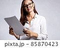 beautiful smiling woman in glasses looking at documents 85870423