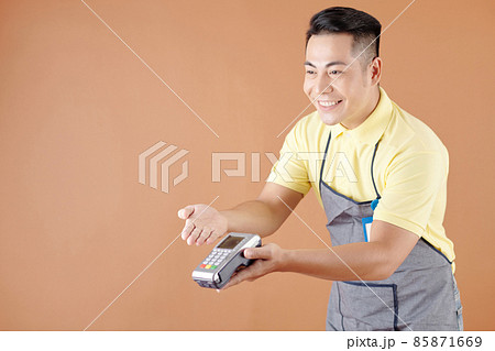 Coffeeshop Waiter Giving Credit Card Reader Coffeeshop Waiter Giving Credit Card Reader 85871669