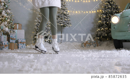 Happy young woman skates on ice rink 85872635