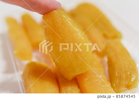 透明のトレイに並んだ丸干しの干し芋 85874545