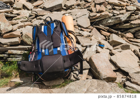 Camping with backpack in the mountains on a sunny summer day. Freedom, happiness, travel and vacations concept, outdoor activities Camping with backpack in the mountains on a sunny summer day. Freedom, happiness, travel and vacations concept, outdoor activities 85874818