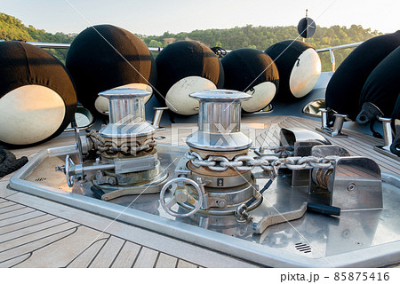 Anchor lowering and raising mechanism, Anchor Buoys and rigging on  the foredeck of a luxurious yacht - selective focus 85875416