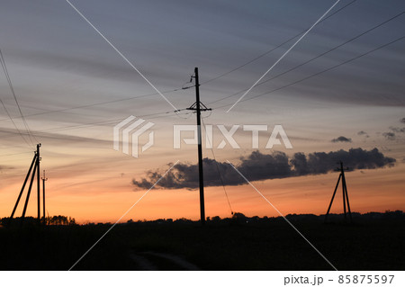 Horizon. Evening dawn, dark sky and a few electric pylons. Horizon. Evening dawn, dark sky and a few electric pylons. 85875597