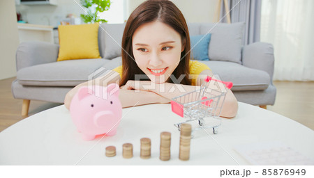 woman plays small shopping cart woman plays small shopping cart 85876949