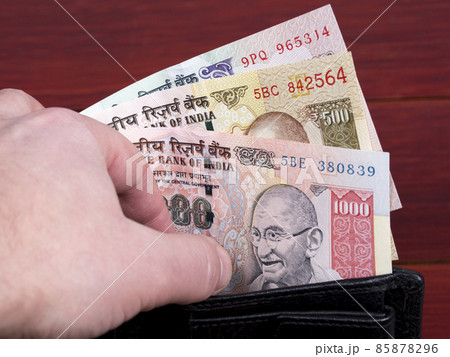 Old Indian money in the black wallet Old Indian money in the black wallet 85878296