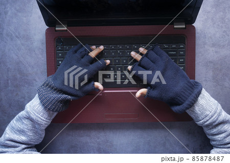 hacker hand stealing data from laptop top down  hacker hand stealing data from laptop top down  85878487