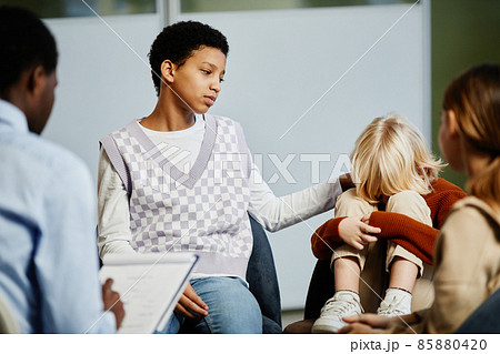 Boy Crying in Group Therapy Session Boy Crying in Group Therapy Session 85880420