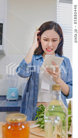 woman look at shopping bills 85880446