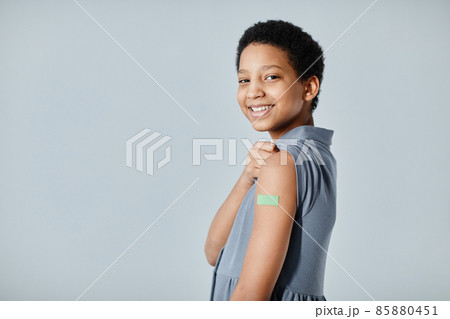 Smiling Girl with Vaccine Plaster Smiling Girl with Vaccine Plaster 85880451